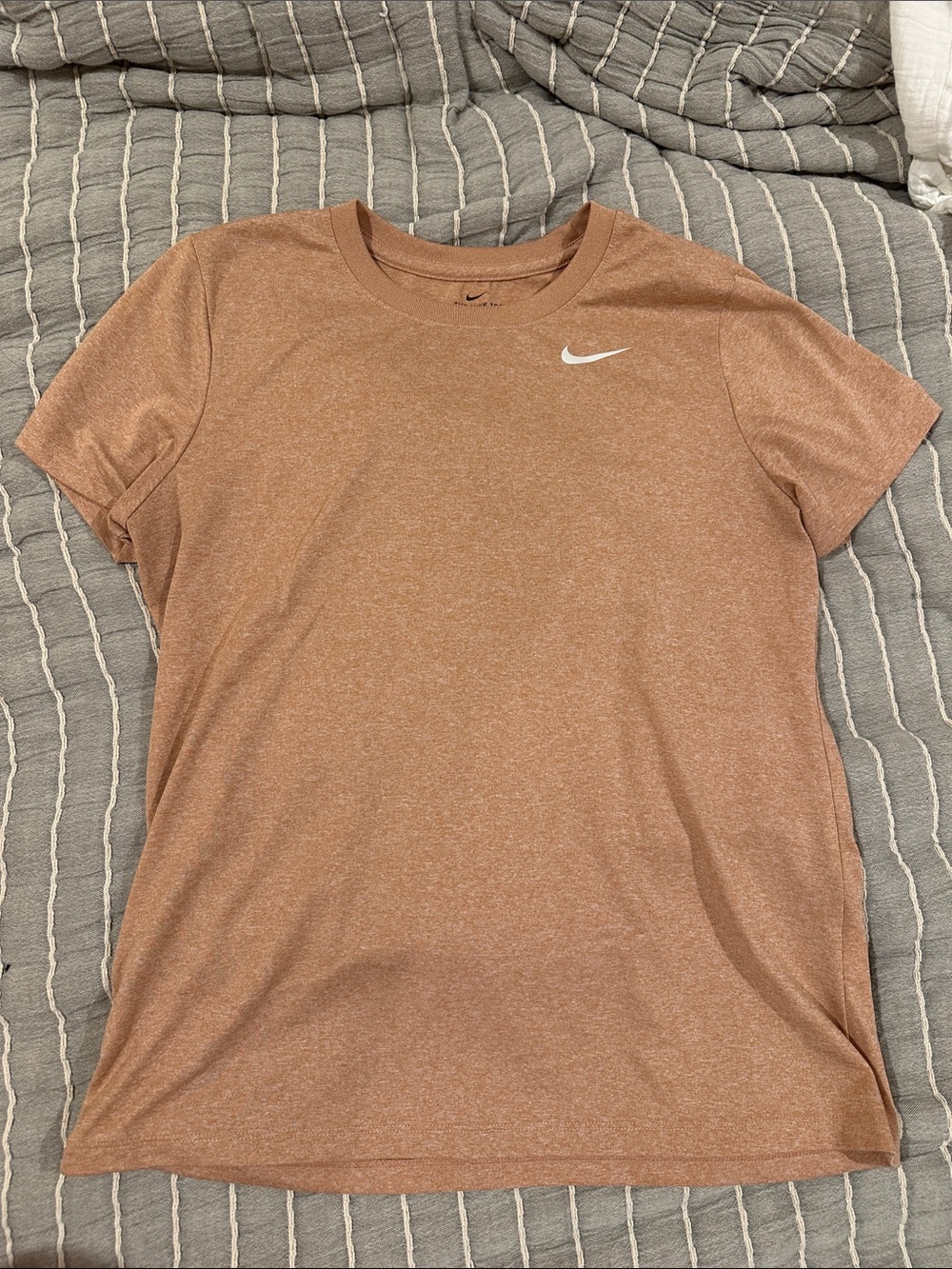 Nike Women's Short-Sleeve Tee in peach/pink with White Swoosh